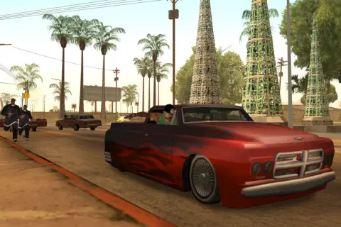 Ucieczka w San Andreas. Czerwony wóz z płomieniami pędzi ulicą, podczas gdy gang ucieka przed policją.